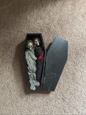 Coffin with death couple inside.
